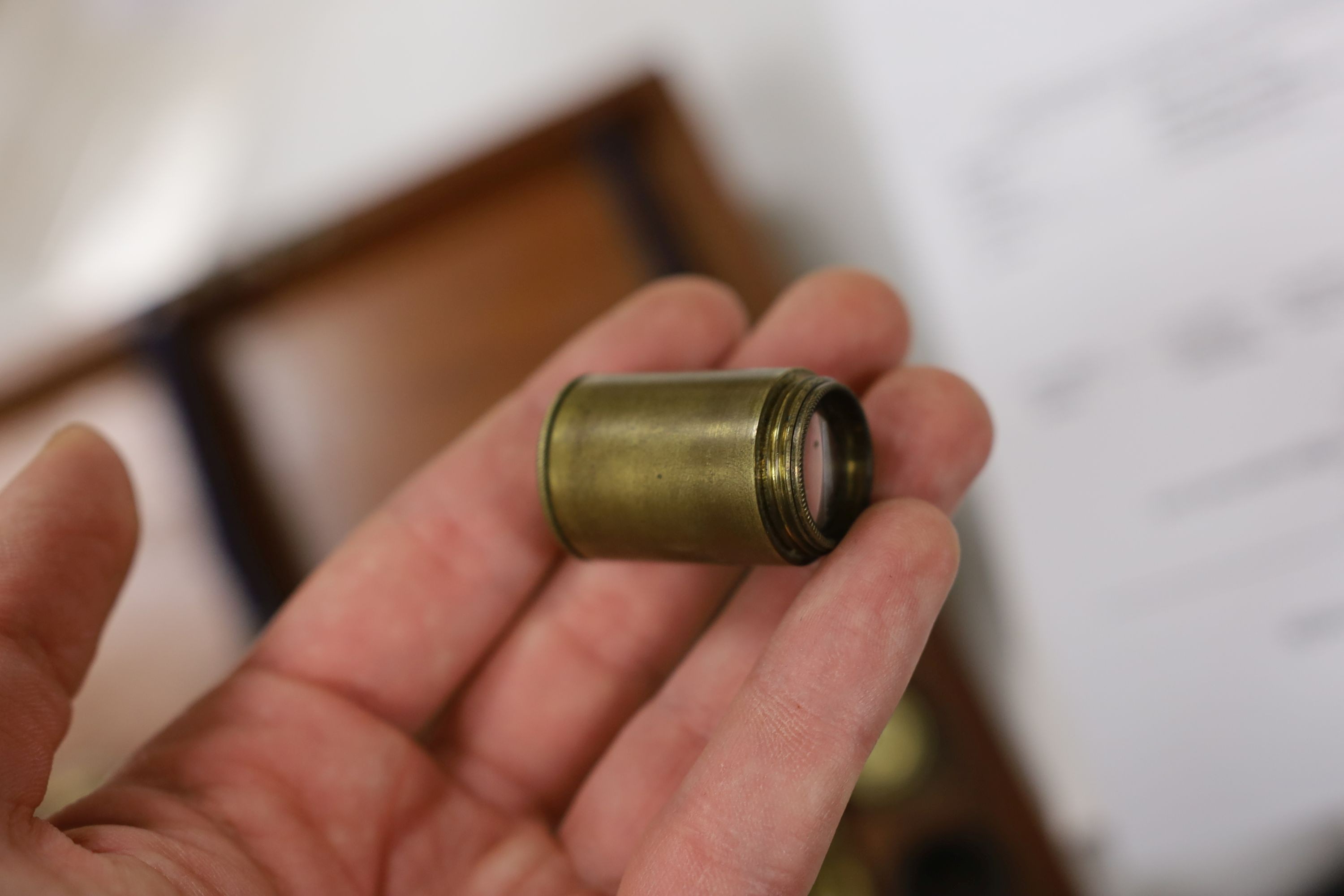 A mahogany cased microscope and a pair of Burdizzo tail dockers, 40cms long